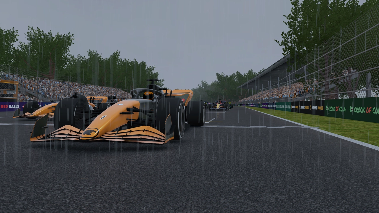 Cars lined up on a wet grid with rain falling.