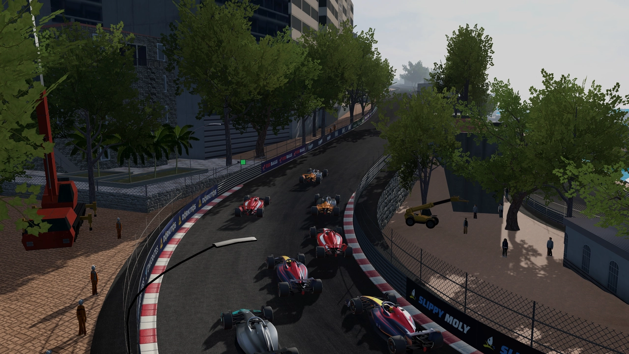 A pack of racing cars driving through the Monaco circuit.